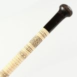 A GOOD INDIAN BONE WALKING STICK, etched with calligraphy, insects and emblems, with wooden knop