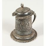 A DUTCH SILVER KITCHEN MUSTARD AND COVER, repousse with cupids. London Import Mark for 1898. 2.75ins