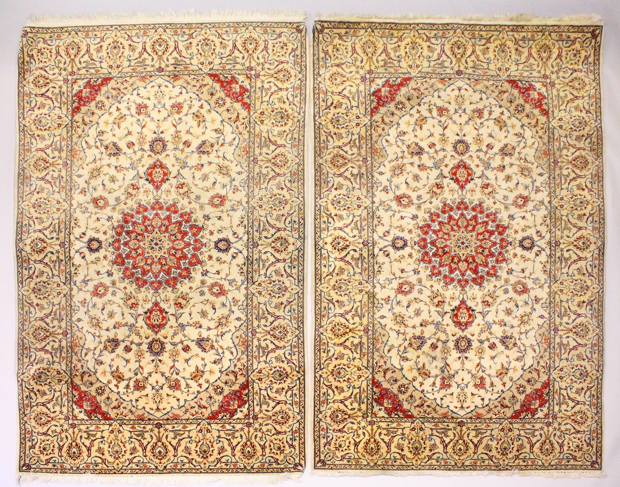 A PAIR OF PERSIAN TABRIZ CARPETS, beige ground with a central medallion and floral decoration (