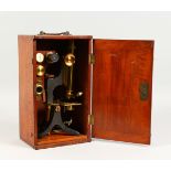 A 19TH CENTURY MAHOGANY CASED BRASS MICROSCOPE. 13.5ins high.