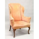 AN 18TH CENTURY MAHOGANY WING ARMCHAIR, with pale pink velvet upholstery, on cabriole legs with
