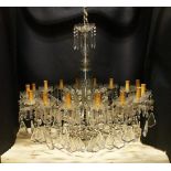 A GOOD LARGE CUT GLASS CHANDELIER, with baluster shape cut glass stem, sixteen small branches with