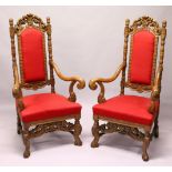 A GOOD PAIR OF JACOBEAN STYLE CARVED OAK HIGH BACK ARMCHAIR, with crimson upholstered backs and