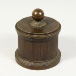 A 19TH CENTURY BRONZE CIRCULAR INKWELL AND COVER. 4ins diameter.