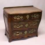 A LOUIS XV STYLE FRENCH OAK SERPENTINE FRONT COMMODE, comprising two short and two long drawers, all