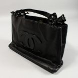 A BLACK CHANEL BAG with two handles, in a Chanel bag.