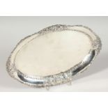 A CONTINENTAL .925 SILVER OVAL DISH, the border with scrolls and cupids. 13ins wide. Weight 12ozs.