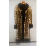 A BRADLEYS LEOPARD SKIN LONG FUR COAT.