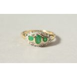 A 9CT GOLD, EMERALD AND DIAMOND RING.
