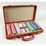 A LEATHER CASED GAMING SET, including playing cards, chips and dice. 16ins wide.