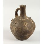 AN EARLY POTTERY WINE BOTTLE. 8.5ins high.