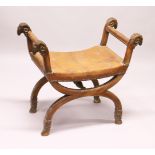 A GOOD 19TH CENTURY WALNUT CROSS FRAMED STOOL, upholstered seat, the arms with rams head terminals