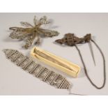 A SILVER BRACELET, FLOWER AND REGIMENTAL CLIP and AN ENGINE TURNED PENCIL.
