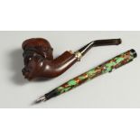 A CARVED WOOD PIPE and A PEN (2).