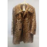 A SHORT OCELOT FUR COAT.