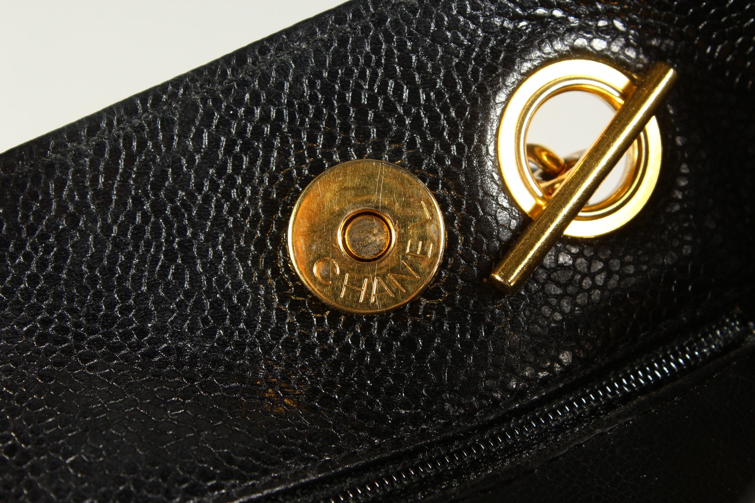 A BLACK LEATHER HANDBAG, with large embossed Chanel logo, leather handle, in a travelling bag. 32cms - Image 6 of 8