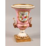 A SEVRES STYLE PINK GROUND PEDESTAL VASE. 10ins high.