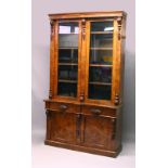 A GOOD VICTORIAN POLLARD OAK CUPBOARD BOOKCASE, with a moulded cornice, pair of glazed doors, the