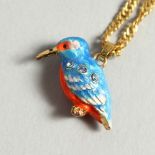 A SMALL ENAMEL KINGFISHER on a chain.