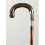 A WALKING STICK with rhino handle and silver band. London 1939. 3ft long.