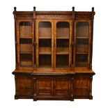 A SUPERB 19TH CENTURY POLLARD OAK AND EBONISED BREAKFRONT LIBRARY BOOKCASE, with a carved cornice,