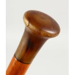 A GOOD WALKING CANE with RHINO HORN HANDLE. 2ft 10ins long.