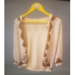 A CREAM SEQUIN JACKET.