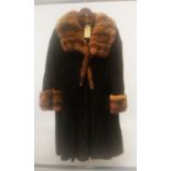 AN E. P. FULL LENGTH MINK COAT with collar and muffs.