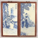 A LARGE PAIR OF FRAMED MOULDED BLUE AND WHITE PORCELAIN PLAQUES, figures in a landscape. 35ins