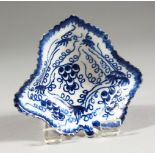 AN 18TH CENTURY BOW LEAF SHAPED DISH, painted with grape vines bearing fruit in under-glaze blue (