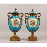 A SUPERB LARGE PAIR OF SEVRES BLUE GROUND TWO-HANDLED URN SHAPED VASES, painted with reverse