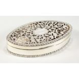 AN ASPREY'S SILVER OVAL BOX with pierced cover. Chester 1915. 6ins long.