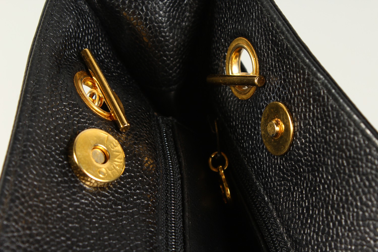 A BLACK LEATHER HANDBAG, with large embossed Chanel logo, leather handle, in a travelling bag. 32cms - Image 7 of 8