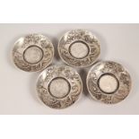 A SET OF FOUR WHITE METAL COIN DISHES. 4ins wide.