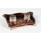 A SUPERB TORTOISESHELL AND PIQUE SILVER SERPENTINE FRONTED INKSTAND, with two bottles. 11.5ins wide.