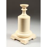 AN EARLY 20TH CENTURY TURNED IVORY STAND, in four parts, on a square base. 9ins high.