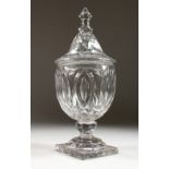 A GOOD 18TH CENTURY IRISH CRYSTAL URN SHAPED CONFITURE AND COVER on a square base. 13ins high.