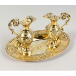 A SMALL PAIR OF FRENCH SILVER GILT WINE AND WATER JUGS (COMMUNION SET), ON AN OVAL STAND by DELJEAN,