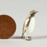 A MINIATURE SILVER AND ENAMEL FIGURE OF A PENGUIN. 1.25ins high.