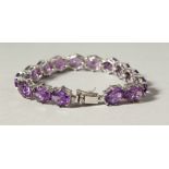 A SILVER BRACELET SET WITH FIFTEEN LARGE AMETHYSTS.