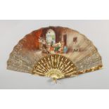 A VICTORIAN BONE FAN, painted with women weaving. 10.75ins long.