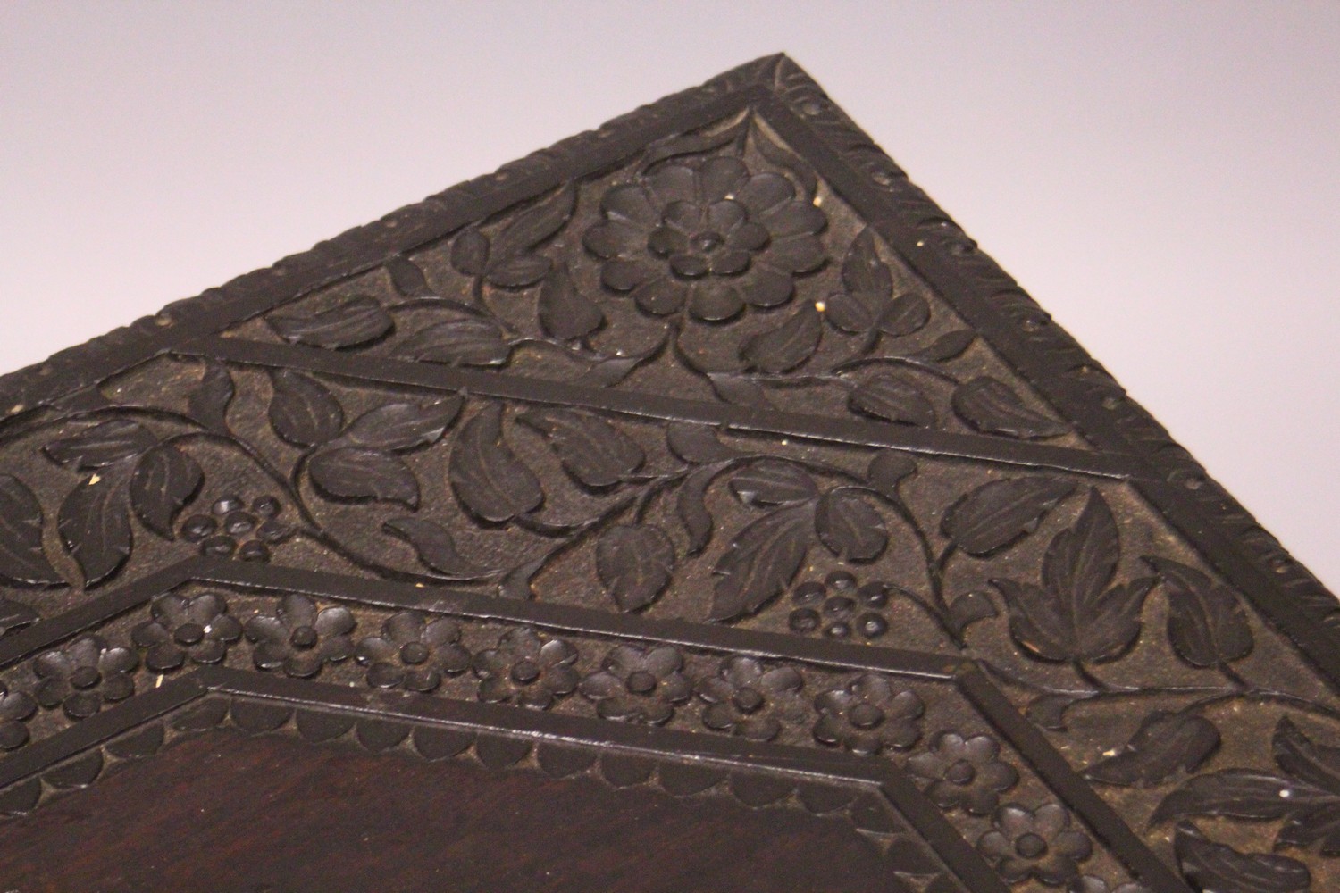 AN EARLY 20TH CENTURY CEYLONESE CARVED EBONY LOW TABLE, with an elephant head leg to each corner. - Image 2 of 5