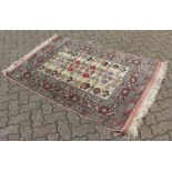 A GOOD PERSIAN SILK RUG, beige ground with allover geometric decoration and stylised animals. 5ft