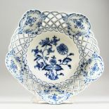 A MEISSEN BLUE AND WHITE ONION PATTERN CIRCULAR PIERCED DISH. Cross swords mark in blue. 8.5ins