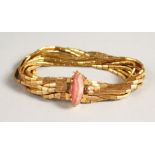 AN 18CT GOLD ELEVEN STRAND BRACELET, with stone clasp. 70gms including stone.