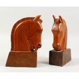 A PAIR OF ART DECO STYLE CARVED WOOD HORSE HEAD BOOKENDS. 8.5ins high.