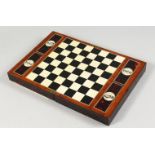 A GOOD 1920'S TORTOISESHELL FOLDING TRAVELLING CHESS SET, with turned wooden pieces.