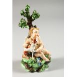 A SMALL DERBY GROUP, "CUPID WITH DOG" on rock, beneath a tree, in colours. 5.5ins high. Incised