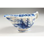 AN 18TH CENTURY BOW SAUCEBOAT, painted in blue under-glaze with a Chinese landscape.
