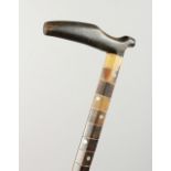 A SEGMENTED STONE WALKING STICK with rhino foot handle. 2ft 10ins long.